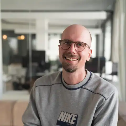 Adrian Schmidt, Mitarbeiter der Castenow GmbH, lächelt in die Kamera.